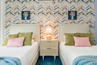 This cheerful twin room blends soft textures with fun patterns—perfect for kids, teens, or friends to relax, recharge, and enjoy their own cozy corner of the home.