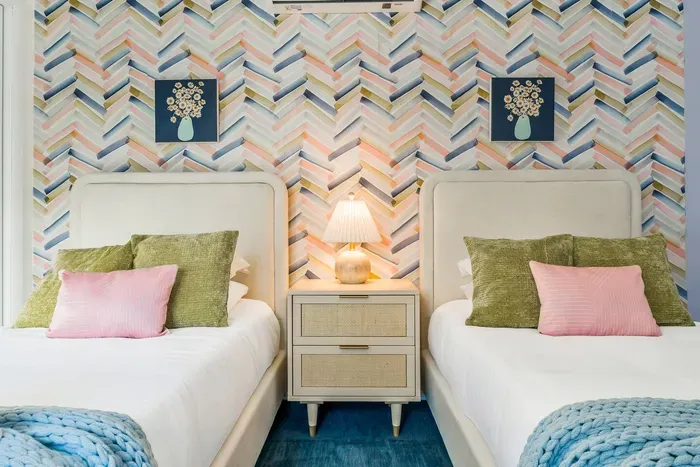 This cheerful twin room blends soft textures with fun patterns—perfect for kids, teens, or friends to relax, recharge, and enjoy their own cozy corner of the home.