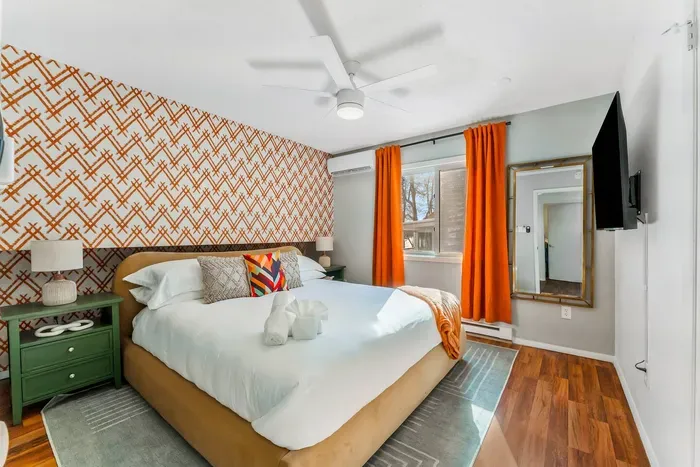 Relax and recharge in this serene retreat with luxe linens, blackout curtains, a smart TV, and calming lake tones—designed for dreamy sleep-ins and cozy evenings in bed.