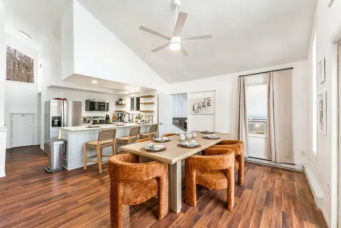 Enjoy the open-concept design of the dining and kitchen area, perfect for entertaining.  The modern kitchen is fully-equipped, while the spacious dining table offers comfortable seating, making it ideal for family meals!