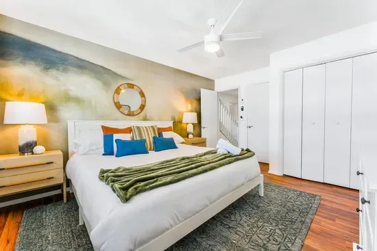 Retreat to the serene primary suite, featuring a plush king bed, nature-inspired mural, and cozy textures. After a day of lakefront adventure or mountain hiking, drift into a restful night’s sleep in this tranquil Poconos hideaway.