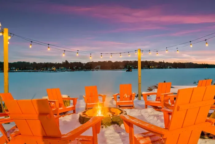 Gather around the fire pit with panoramic lake views as the sunset paints the sky.  Twinkling string lights and cozy seating create a magical space for stargazing, storytelling, and creating lasting memories.