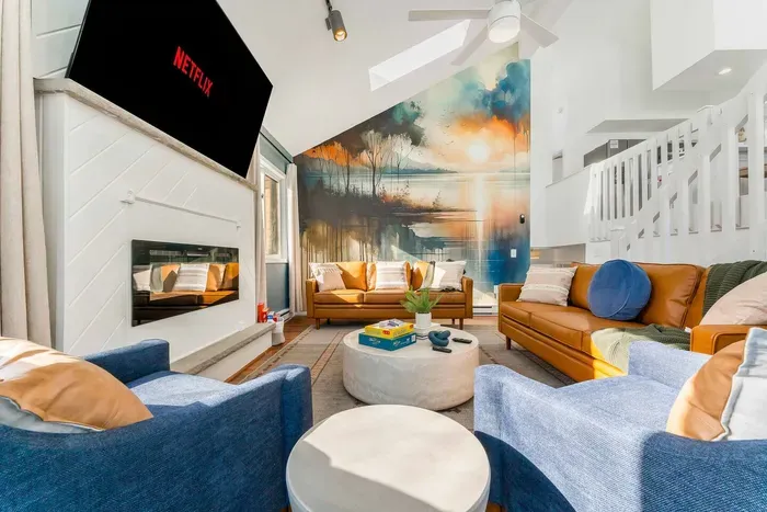 Soaring ceilings and lake-inspired design make this living room the heart of Water’s Edge Hideaway. Stream Netflix, curl up by the fireplace, and soak in the natural light-the perfect Poconos space to relax, reconnect & capture Insta-worthy moments.