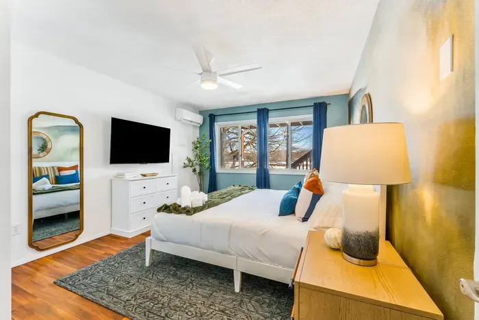 Relax and recharge in this serene retreat with luxe linens, blackout curtains, a smart TV, and calming lake tones—designed for dreamy sleep-ins and cozy evenings in bed.