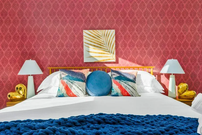 A vibrant retreat with statement style—this bold bedroom features a plush king bed, luxe linens, and colorful details that turn every night into a boutique-style stay.