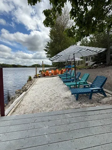 Your private lakefront oasis—complete with cozy sectional seating, a sandy beach area, and a front-row seat to sparkling water views. Morning coffee or sunset wine, this is the spot!