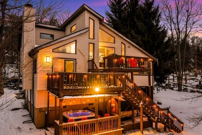 Experience the perfect blend of cozy luxury and outdoor adventure at this stunning lake house. With multiple decks, a hut tub, barrel sauna and beautiful lighting, it's a serene escape in every season!