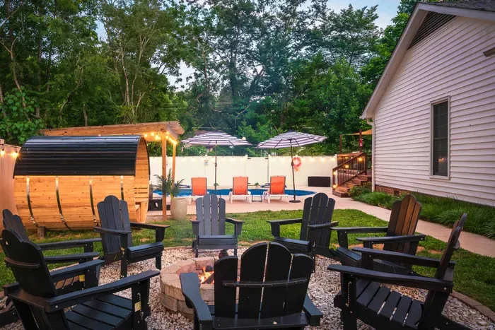 Private backyard oasis with pool, fire pit, and cozy evening ambiance