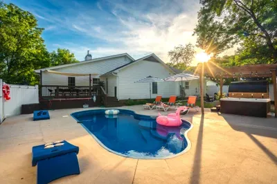 Private backyard oasis with pool, hot tub, pergola, and sunny lounge area