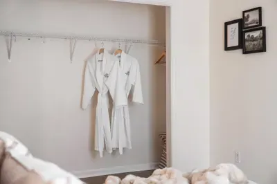 Spacious open closet with plush robes for a hotel-style stay