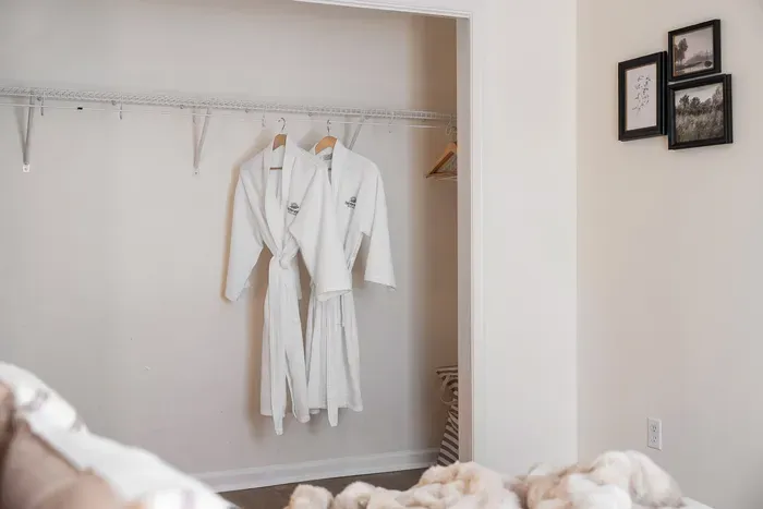 Spacious open closet with plush robes for a hotel-style stay