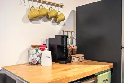 Cozy coffee station with stocked essentials and charming hanging mugs