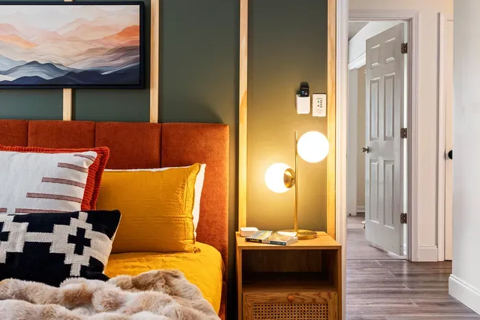 Warm modern bedroom with bold accents, cozy textures, and stylish lighting