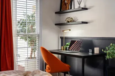 Bright, stylish workspace with natural light and a bold accent chair