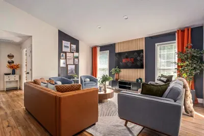 Bright, stylish living room with comfy seating and large smart TV