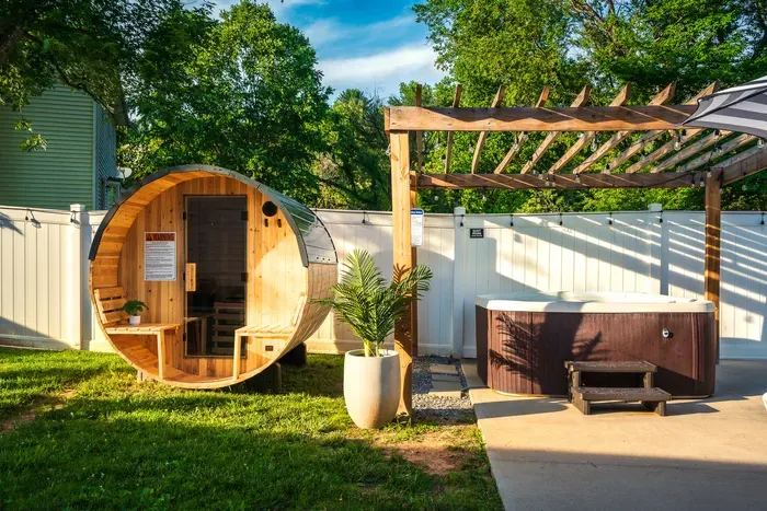 Private backyard spa retreat with hot tub, sauna, and pergola