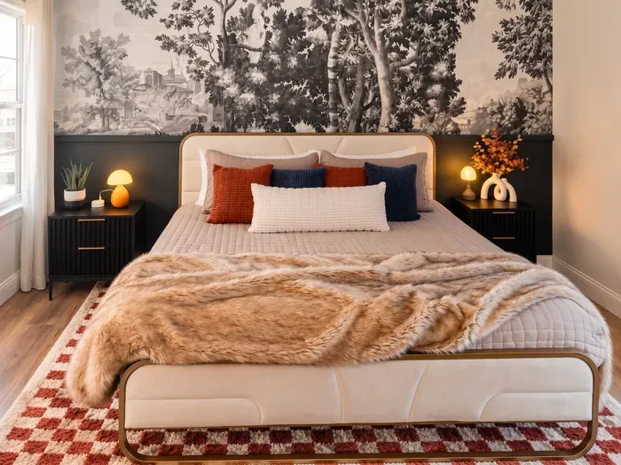 Boutique-style bedroom with statement mural and plush, cozy bedding