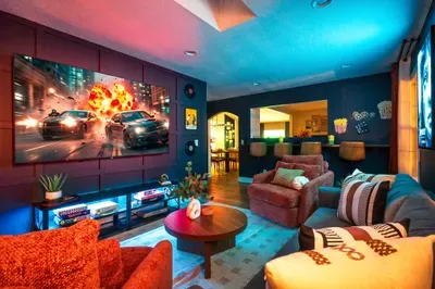 Cozy media lounge with big-screen theater vibes and stylish bar seating