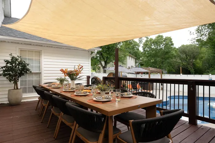 Shaded poolside deck with stylish outdoor dining for the whole group