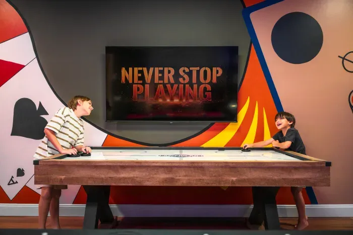 Colorful game room with air hockey table and big-screen TV fun
