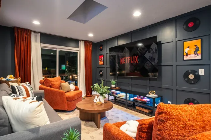 Cozy media room with big-screen TV, bold decor, and lounge seating