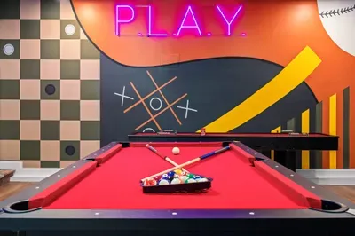 Bold game room with neon art and pool table fun