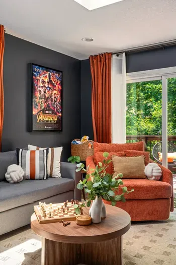 Bright, stylish lounge with cozy seating and peaceful treetop views