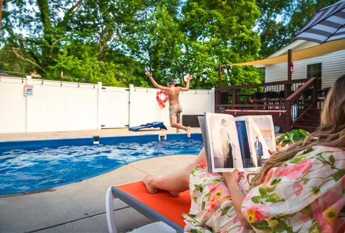 Private backyard pool oasis with lounge space and shaded deck