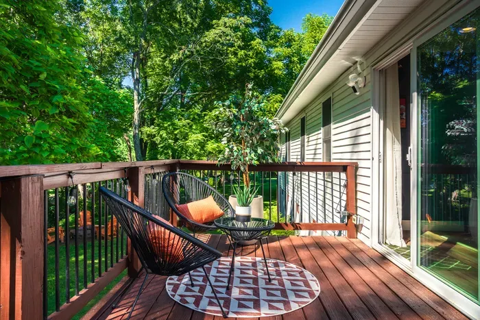 Private tree-lined deck with cozy seating for peaceful outdoor lounging