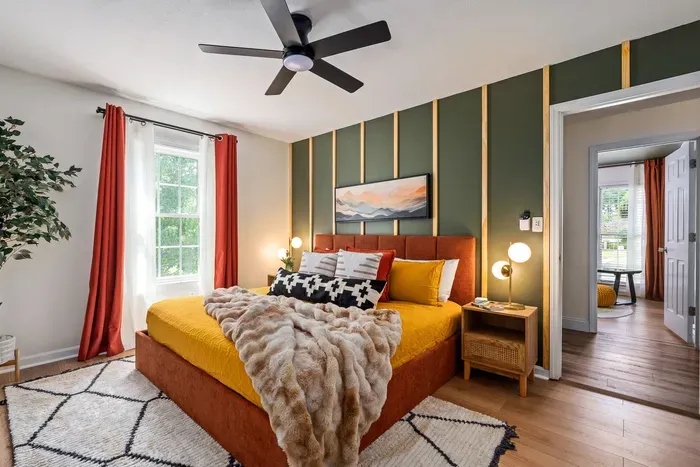 Stylish king bedroom with bold accent wall, cozy textures, and natural light