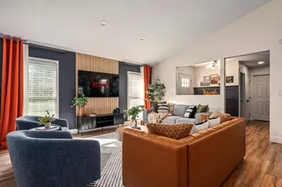 Stylish modern living room with cozy seating and large smart TV