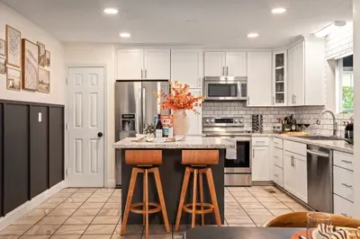 Bright modern kitchen with island seating and stainless steel appliances