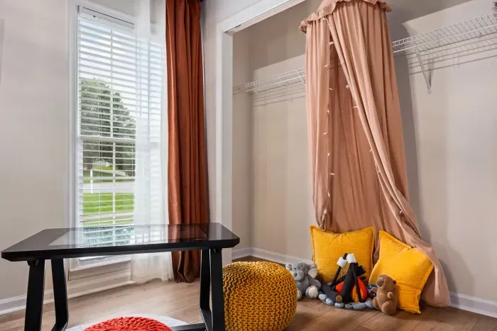 Bright flex room with window light, desk, and charming kids’ play nook