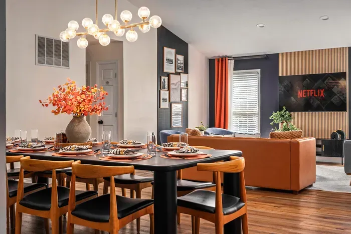 Stylish open living and dining space with designer touches and TV lounge