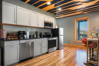 The second kitchen is the unsung hero of a twenty-person trip. Pancakes happen down here while the upstairs crew sleeps in, and nobody crosses paths at the coffee bar.