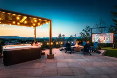 Movie up on the screen, the hot tub warm, fire pit going, the ridgeline fading into dusk. The kind of night that's the whole reason you booked the mountain place.
