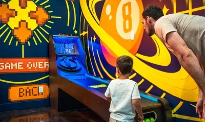 Skee-ball with the kid, balls already in hand, the game you forgot you missed until you stepped down here. The trip memory they actually tell their friends about.