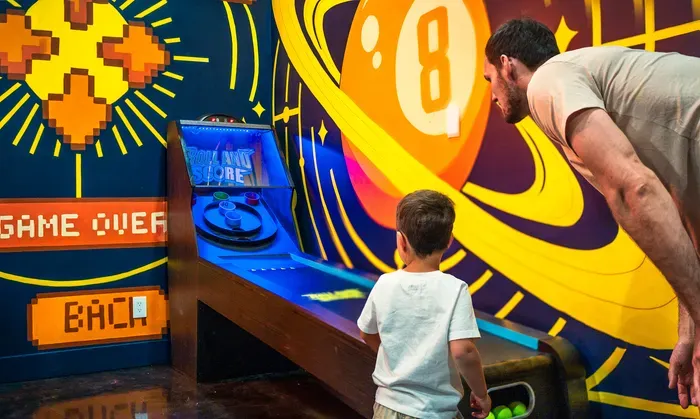 Skee-ball with the kid, balls already in hand, the game you forgot you missed until you stepped down here. The trip memory they actually tell their friends about.
