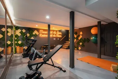 Roll out a mat in the gym for the morning stretch before the trail day starts. Spin bike, bench, dumbbells, all queued for whoever wakes up first and wants the room quiet.