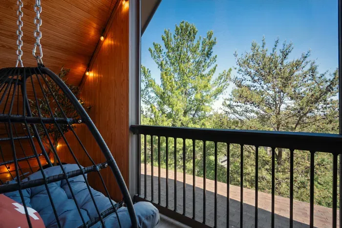 Claim the screened balcony when the house gets busy. Swing chair, tree view, and a little distance from the action without disappearing from the trip.
