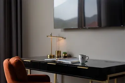 A dedicated workspace tucked into the primary suite means a quick morning call can happen without leaving your coffee, your TV, or your view behind for a single minute.