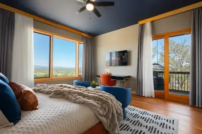 Wake to Blue Ridge ridgelines through the windows, then slip onto your private balcony with a hot cup and claim the first quiet hour while the house is still asleep behind you.