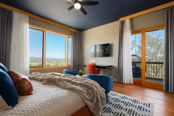 Wake to Blue Ridge ridgelines through the windows, then slip onto your private balcony with a hot cup and claim the first quiet hour while the house is still asleep behind you.
