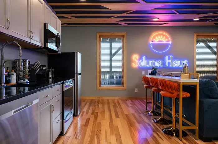 The lower kitchen with its own island bar for the late-night snack run and the early breakfast crew. A second kitchen means nobody is ever waiting for the toaster.
