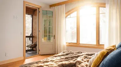 Wake up with balcony light pouring in, then step outside before the house starts moving. This bedroom turns the first hour into the best one.