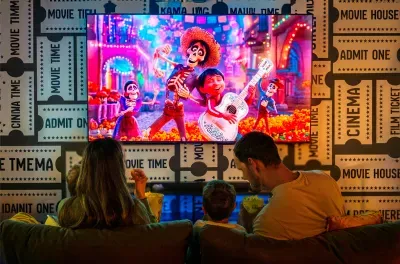 Kids movie night, three across the sofa, the animated feature already rolling. The after-dinner anchor that buys the adults their quiet hour upstairs with the wine still on the table.