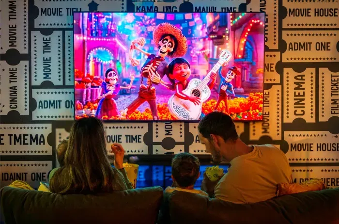 Kids movie night, three across the sofa, the animated feature already rolling. The after-dinner anchor that buys the adults their quiet hour upstairs with the wine still on the table.