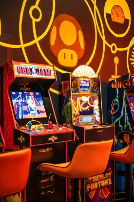 Retro arcade game room with classic machines and bold, colorful vibes