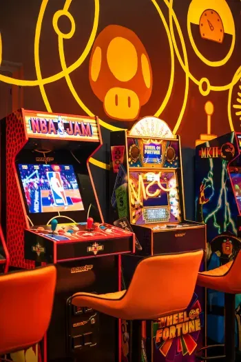 Retro arcade game room with classic machines and bold, colorful vibes