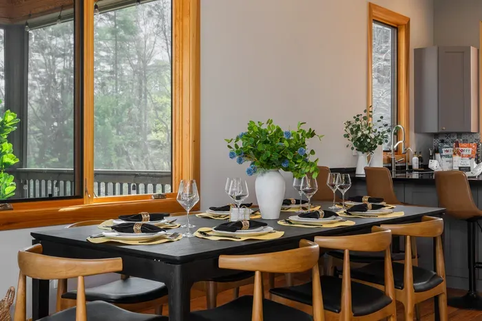 Slow Sunday dinner at the long table with the trees through the window and a second pour going around. Asheville turns one course into three without anyone trying.